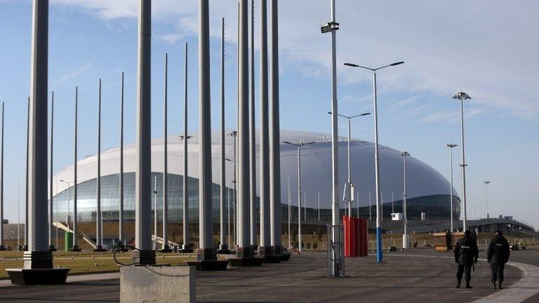 Security guards walk near the Olympic Park in Adler, Russia, 9 January