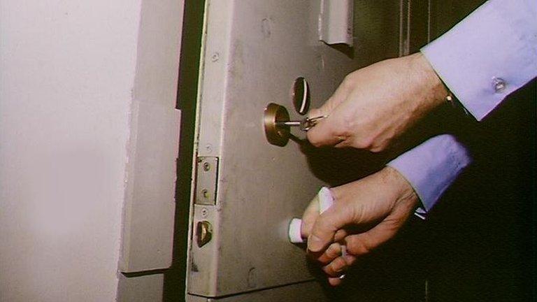 Police officer locking cell