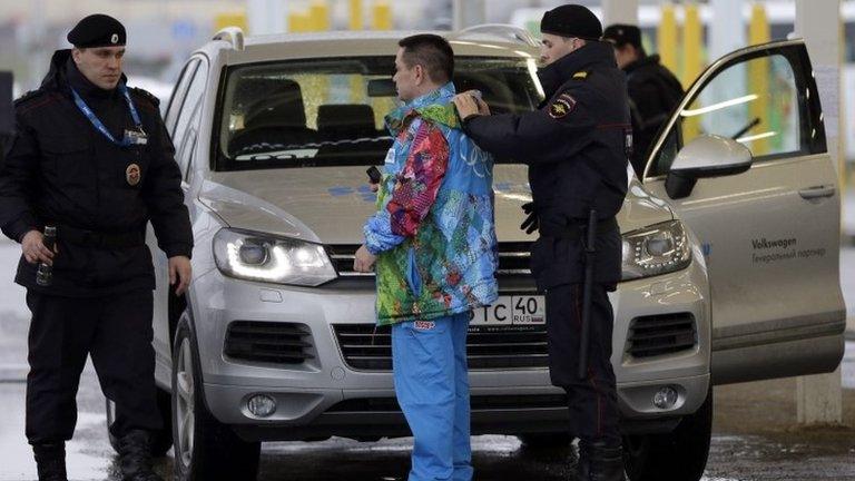 Russian police search a driver and his vehicle at the entrance to the Sochi Olympic park. Photo: 23 January 2014