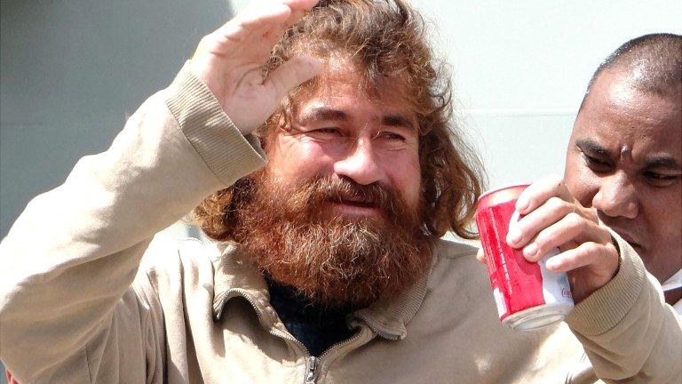 Jose Salvador Alvarenga walks with the help of a nurse in Majuro