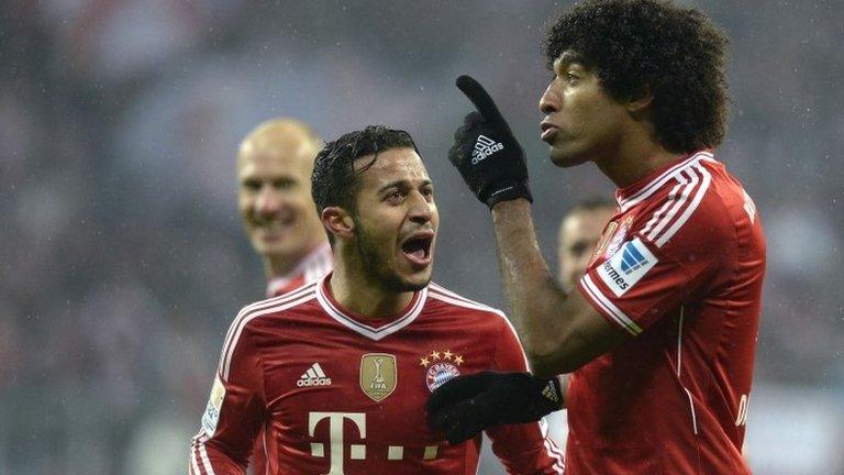 Bayern Munich's Spanish midfielder Thiago Alcantara and Bayern Munich's Brazilian defender Dante celebrate