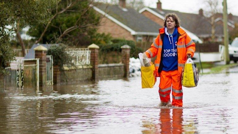 A man walked through a flooded street in Moorland, on the Somerset Levels