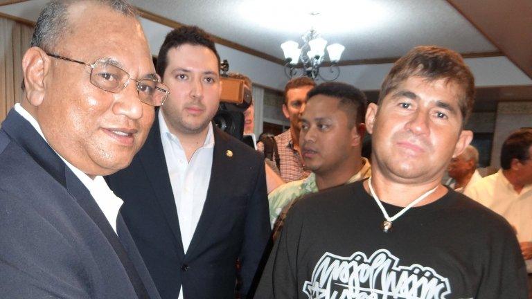 Jose Salvador Alvarenga (R) of El Salvador shakes hands with Marshall Islands President Christopher Loeak prior to his departure at the airport in Majuro on February 10, 2014.