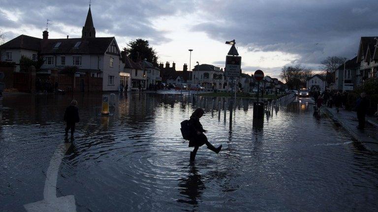 A child playing in flood water in Datchet, Berkshire