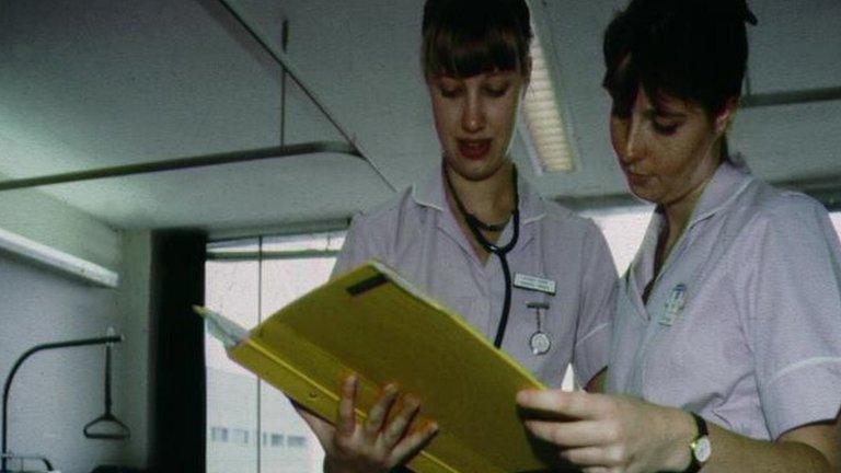 Two nurses holding a folder