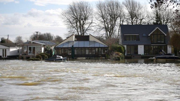 High water levels in the river Thames threaten housing near Penton Hook Weir