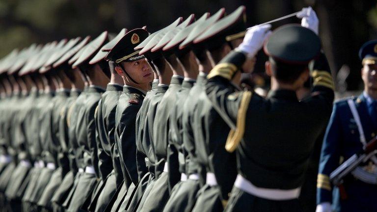 Chinese People's Liberation Army soldiers and officers line up in preparation to welcome visiting Indian Prime Minister Manmohan Singh in Beijing on 23 October 2013