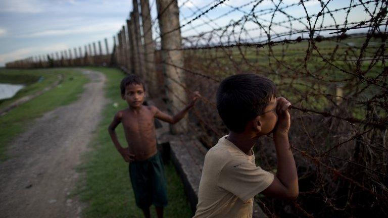 File photo: a Muslim boy looks through a barbed wire fence on the border of Myanmar and Bangladesh in Maungdaw, Rakhine state, Myanmar, 11 September 2013