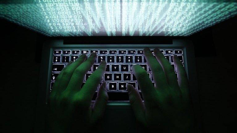 Person typing on a computer keyboard