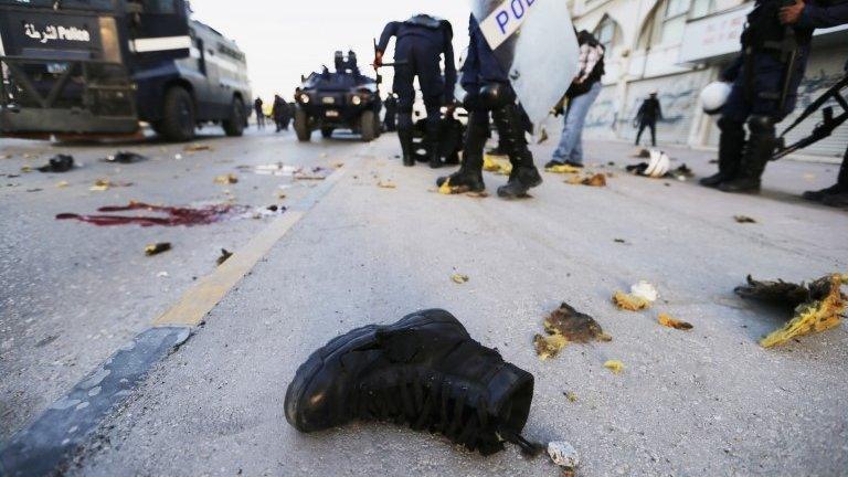 Boot of a riot police officer lies on a street after an explosion in the village of Daih (3 March 2014)