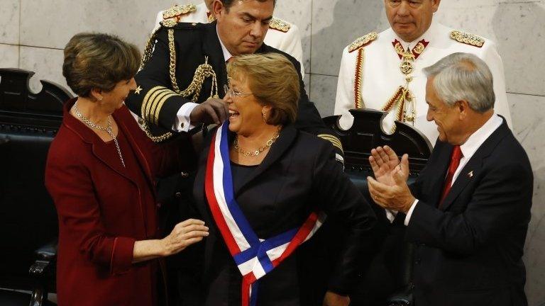 Chile's new President Michelle Bachelet (center) receives the presidential sash from Senate President Isabel Allende (left) after being sworn in during a ceremony before congress in Valparaiso on 11 March, 2014