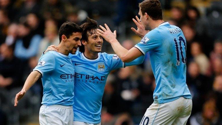 Edin Dzeko celebrates with his Man City team-mates