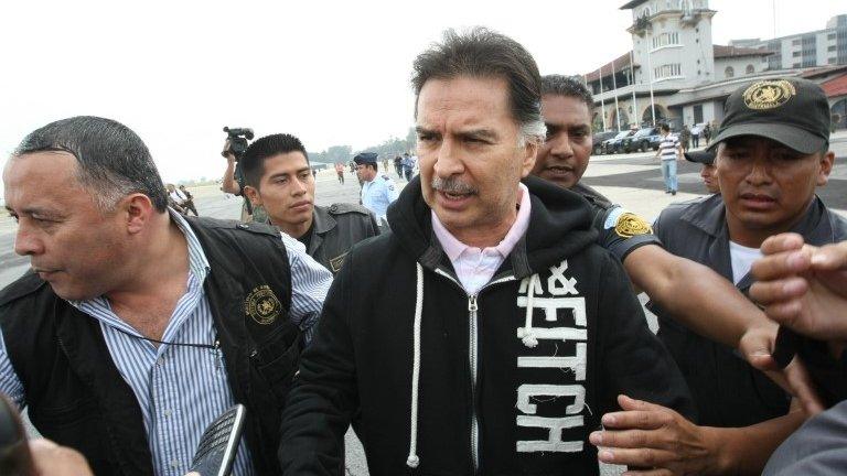 Alfonso Portillo (centre) is taken under custody to board the aircraft to be extradited to the United States on 24 May , 2013