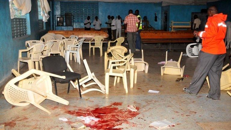 Blood stains on the church floor as Kenyan plaincloths police officer investigate inside Kenyan Joyland church in Likoni, near Mombasa, Kenya Sunday, March 23, 2014.