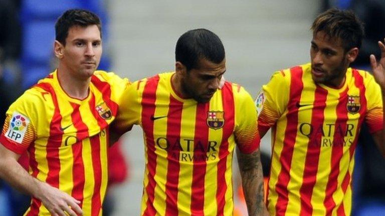 Lionel Messi, left, celebrates after scoring a penalty with team-mates Neymar, right, and Daniel Alves