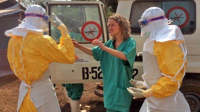 In this photo provide by MSF, Medecins Sans Frontieres (Doctors without Borders), taken on Friday, March 28, 2014, healthcare workers from the organisation, react, as they prepare isolation and treatment areas for their Ebola, hemorrhagic fever operations, in Gueckedou, Guinea.