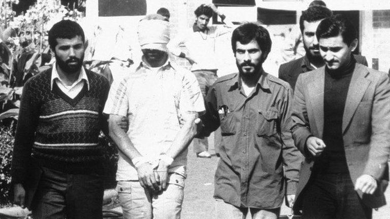 A blindfolded American hostage is paraded by his captors in the compound of the US Embassy Tehran, Iran