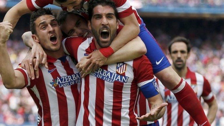 Atletico Madrid's Raul Garcia (front) is congratulated by team mates Jorge "Koke" Resurreccion (left) and David Villa