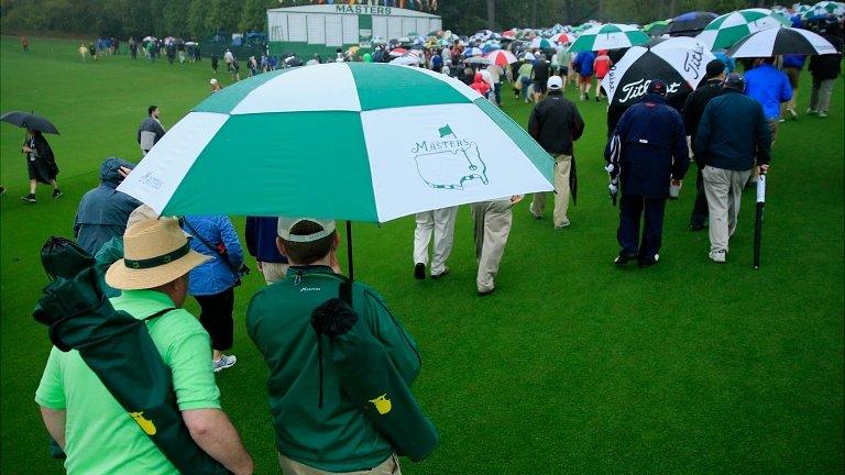 Spectators are evacuated from the course after play was suspended due to weather during a practice round