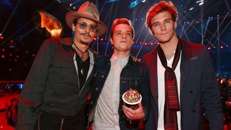 Johnny Depp poses with Josh Hutcherson and Sam Claflin