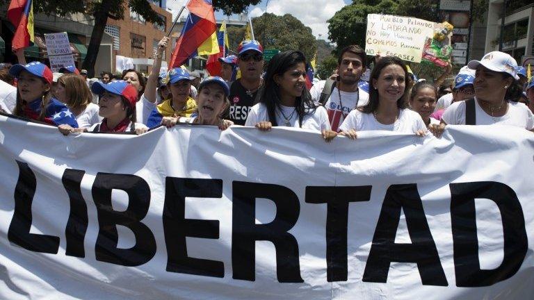 Opposition politicians take part in a march demanding the freeing of opposition leaders detained during recent protests on 29 March, 2014