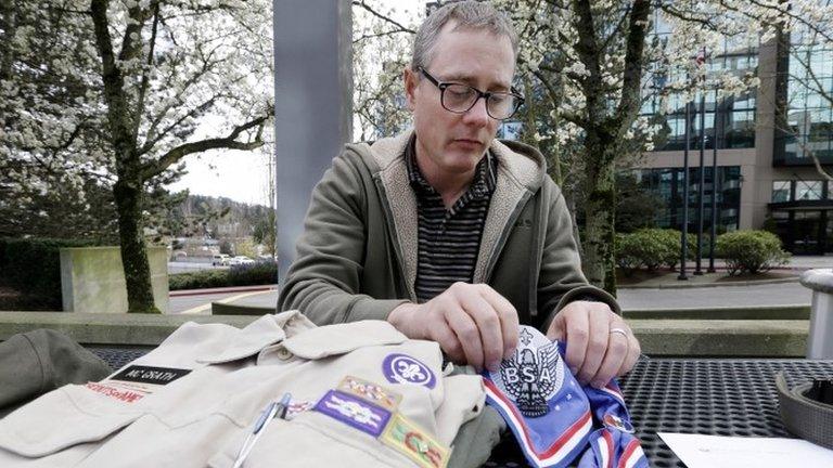 Geoff McGrath displays his Boy Scout scoutmaster uniform shirt and other scout items for the Seattle troop he led, in Bellevue, Washington 1 April 2014