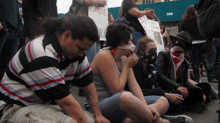 Protesters sit in downtown Albuquerque, New Mexico 30 March 2014