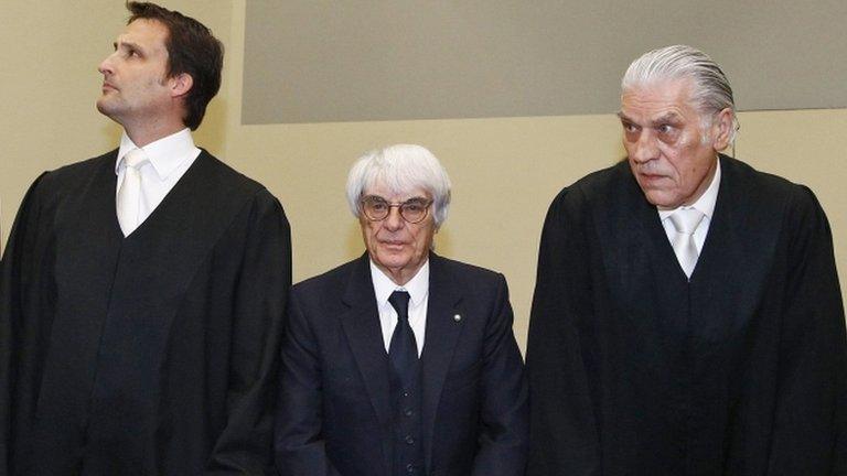 Bernie Ecclestone, center, stands with his lawyers in court in Munich, southern Germany - 24 April 2014