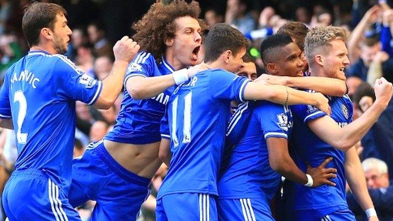 Chelsea players celebrate a goal against Arsenal