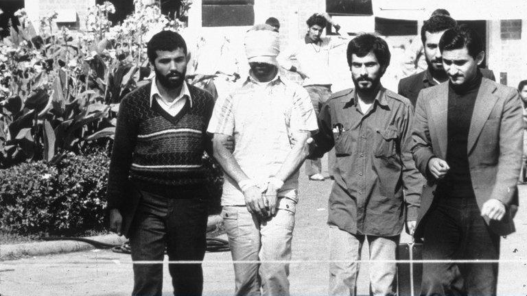 An American hostage with Iranian captors in Tehran, Iran, in 1979