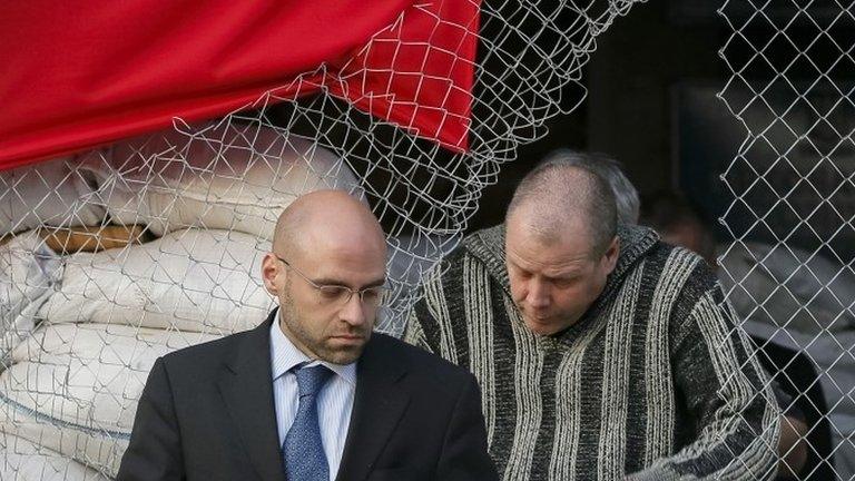 Detained international observer (R)leaves mayor's office in Sloviansk with OSCE official (L) 27/04/2014