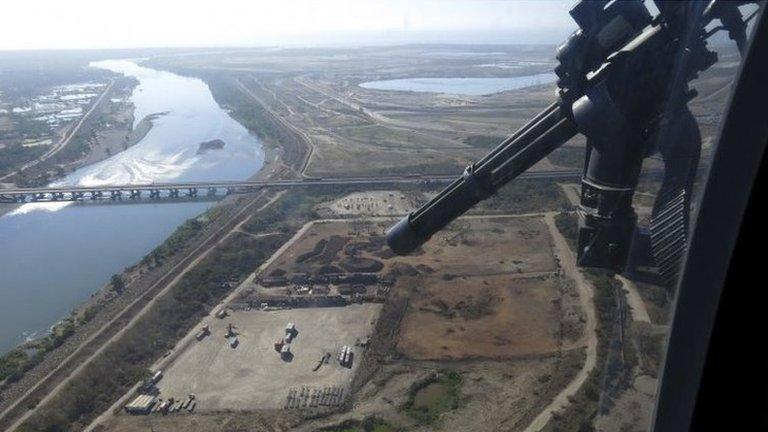 Mexican federal police fly over the Balsas River near the Pacific port of Lazaro Cardenas on 14 March 2014