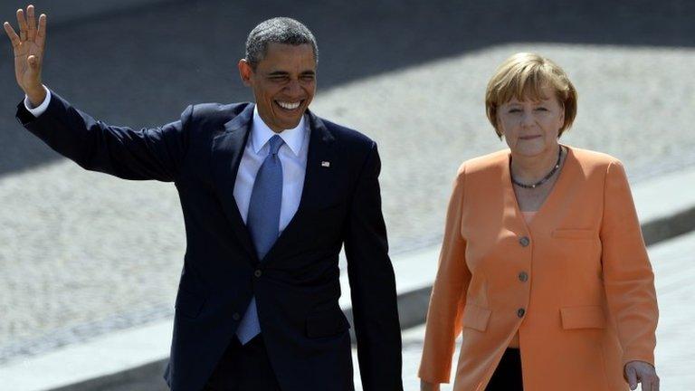 US President Barack Obama and German Chancellor Angela Merkel arriving at the Brandenburg Gate in Berlin 19 June 2013