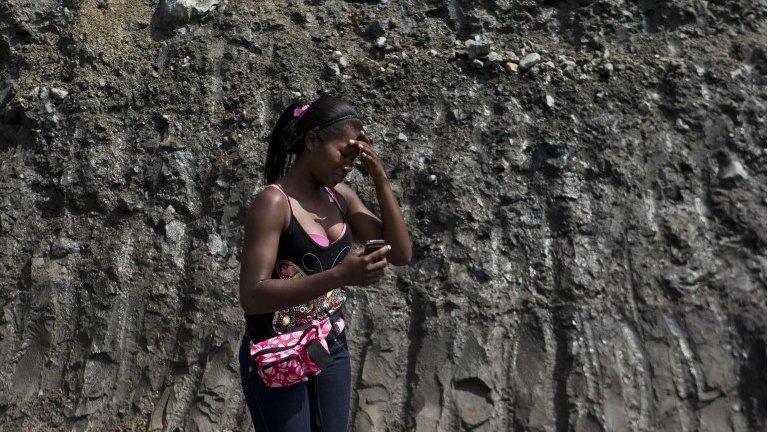 Woman cries at collapsed mine in Colombia