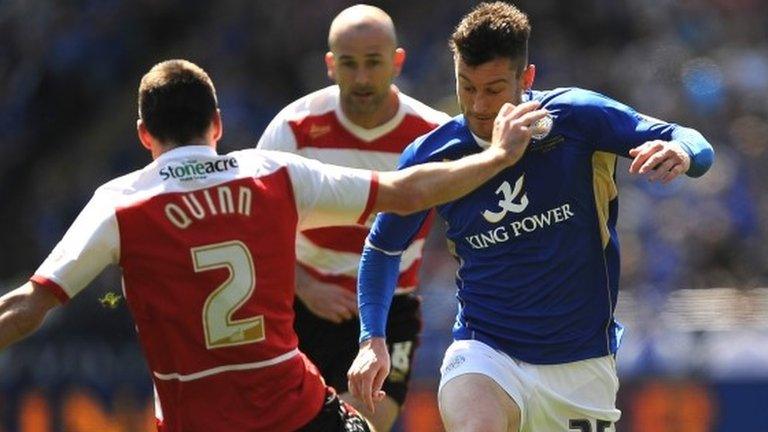 Leicester City's David Nugent (right) and Doncaster Rovers' Paul Quinn battle for the ball