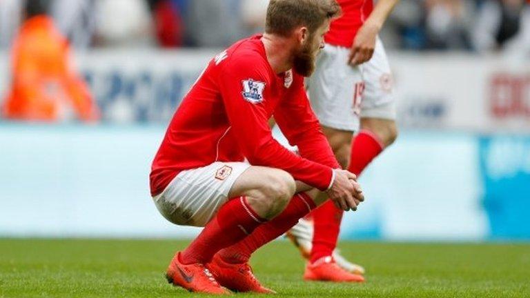 Cardiff's Aron Gunnarsson is left dejected after his side's relegation