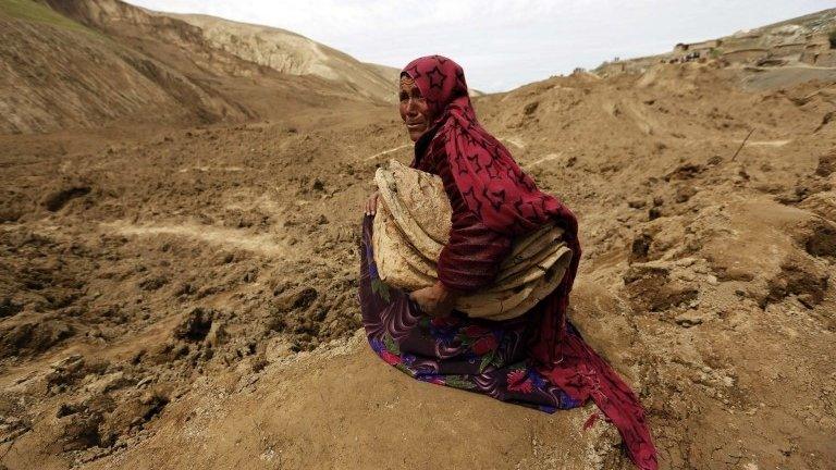 An Afghan woman cries after she lost her family in a landslide at the Argo district in Badakhshan province, 4 May 2014