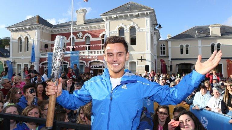 Tom Daley with the baton in Jersey