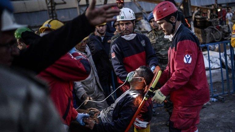 Rescuers evacuate a colleague after inhaling smoke at a mine in Soma, Turkey, on 15 May 2014