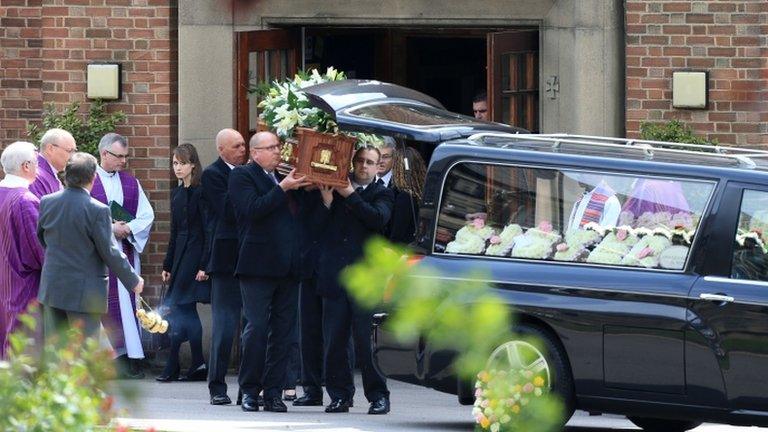 Ann Maguire's coffin is placed into hearse