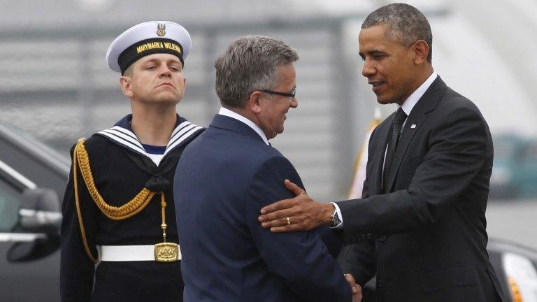 US President Barack Obama (right) is greeted by Poland's President Bronislaw Komorowski upon his arrival in Warsaw, 3 June 2014