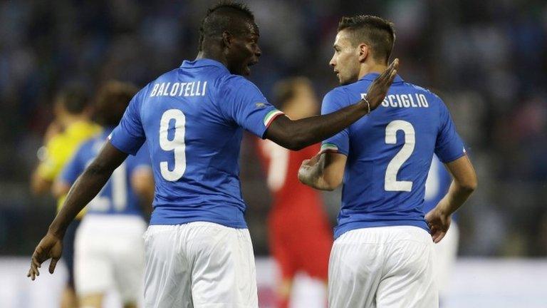 Italy forward Mario Balotelli, left, talks with his team-mate defender Mattia De Sciglio