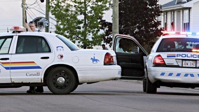 Police take cover in Moncton. 4 June 2014