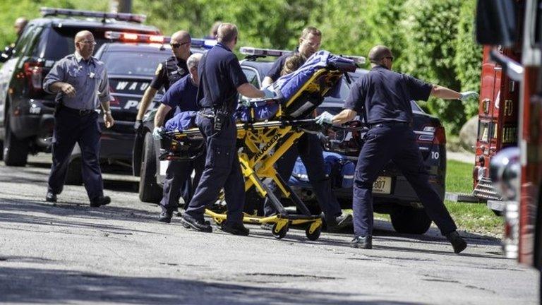 Rescue workers take a stabbing victim to the ambulance in Waukesha, Wisconsin 31 May 2014