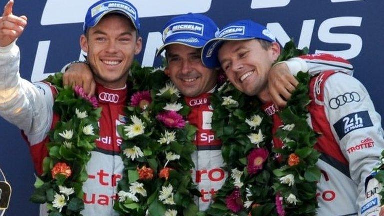 Audi's Andre Lotterer Benoit Treluyer and Marcel Fassler celebrate on the podium