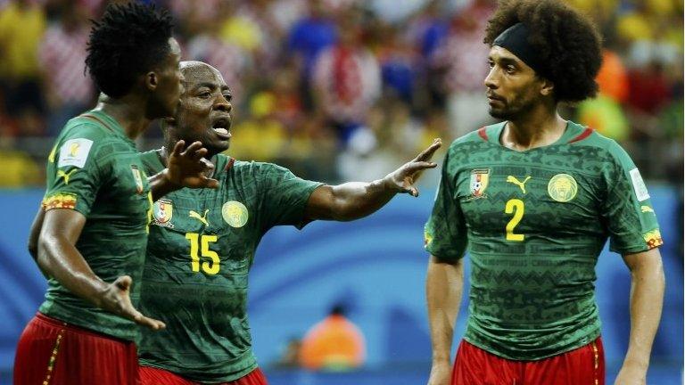 Cameroon's Pierre Webo (centre) tries to separate team-mates Benjamin Moukandjo (left) and Benoit Assou-Ekotto