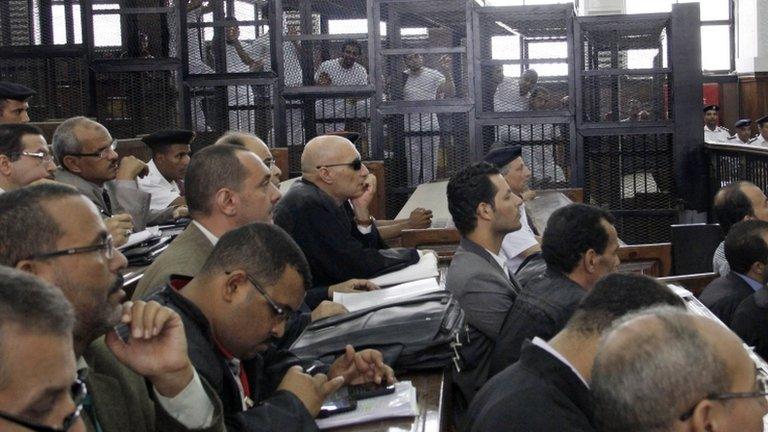 Lawyers attend the sentencing hearing for journalists working for Al-Jazeera in a courtroom in Cairo, Egypt