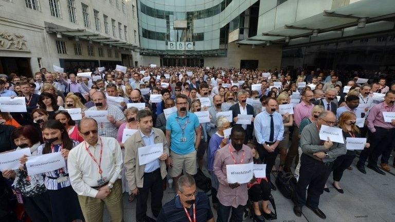 BBC journalists in London join colleagues from other news organisations for a silent protest outside New Broadcasting House