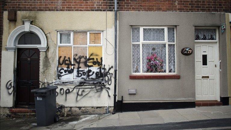 One derelict house next door to a well-kept house