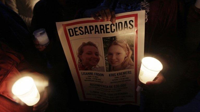 Residents hold candles and missing persons posters during a public vigil to find two missing Dutch tourists in Boquete on 28 May, 2014